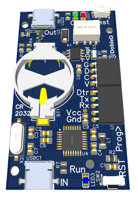 Blue development board with labelled Run, Prog, and serial headers; features a large white circular component with a yellow indicator, USB connectors, and a microcontroller chip.